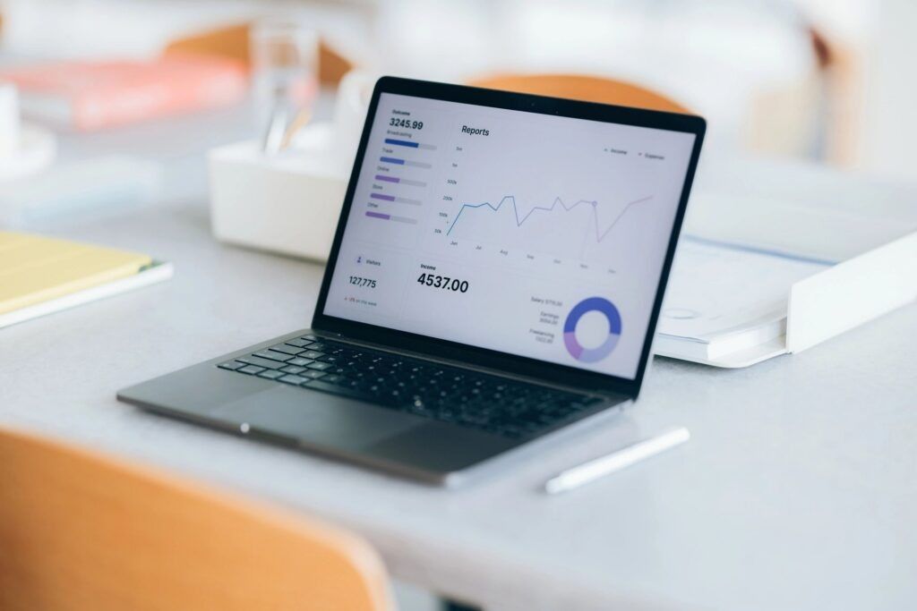 Laptop showing a website analytics dashboard with traffic and inquiry reports