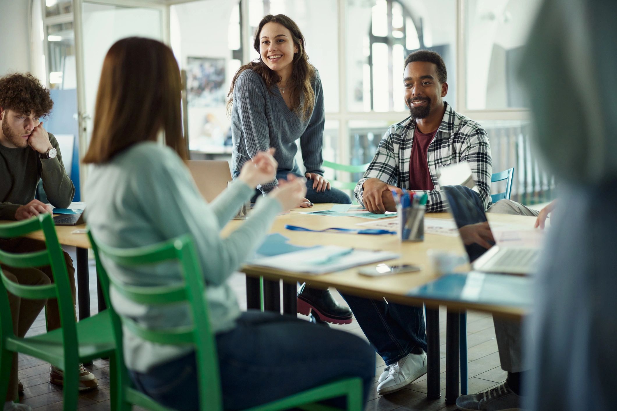 Happy freelancers talking on a meeting at casual office.
