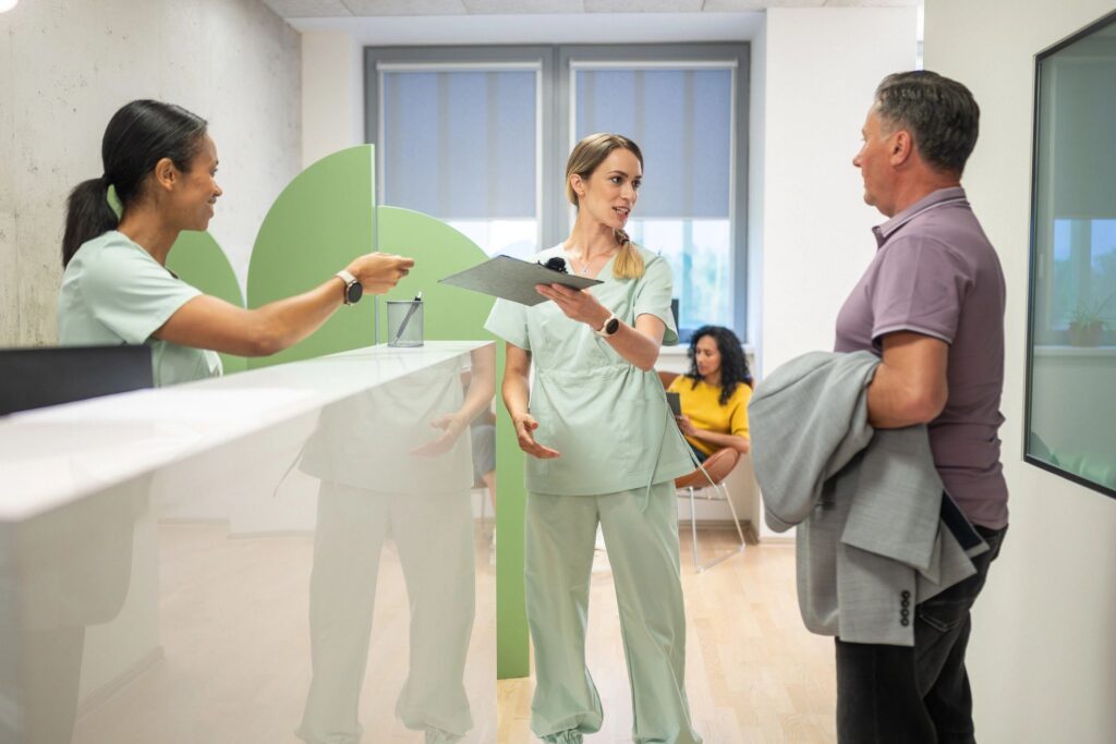Healthcare Professionals Discussing Treatment Options with a Patient in a Clinic